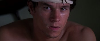 Movie still from “Boogie Nights” (1997), directed by Paul Thomas Anderson – A person with a bandage on his head; Close Up shot, Low angle