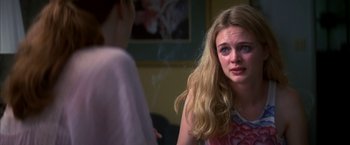 Movie still from “Boogie Nights” (1997), directed by Paul Thomas Anderson – A woman sitting in front of another woman in front of a mirror; Close Up shot, Over the shoulder angle