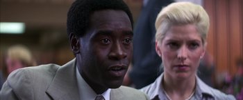 Movie still from “Boogie Nights” (1997), directed by Paul Thomas Anderson – A man and a woman are looking at the camera; Close Up shot, Over the shoulder angle