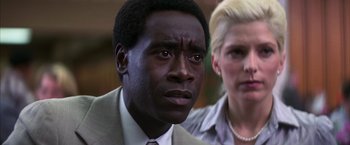 Movie still from “Boogie Nights” (1997), directed by Paul Thomas Anderson – A man and a woman are looking at the camera; Close Up shot, Low angle