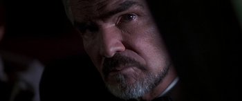 Movie still from “Boogie Nights” (1997), directed by Paul Thomas Anderson – A man with a beard; Close Up shot, Low angle