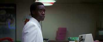 Movie still from “Boogie Nights” (1997), directed by Paul Thomas Anderson – A man in a white shirt is standing in a room; Close Up shot, Over the shoulder angle