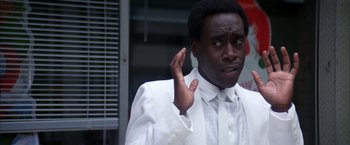 Movie still from “Boogie Nights” (1997), directed by Paul Thomas Anderson – A man in a white shirt and a white jacket; Close Up shot, Over the shoulder angle