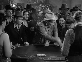 Movie still from “Boom Town” (1940), directed by Jack Conway – A group of men playing a game of roulette; Medium shot, High angle