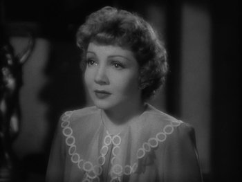 Movie still from “Boom Town” (1940), directed by Jack Conway – An old photo of a woman in a white dress; Close Up shot, High angle
