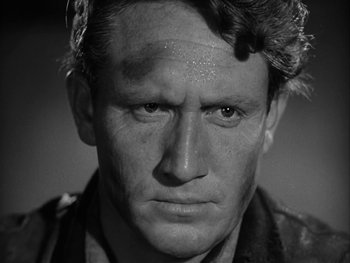 Movie still from “Boom Town” (1940), directed by Jack Conway – An old black - and - white photo of a man's face; Close Up shot, Over the shoulder angle