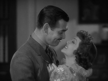 Movie still from “Boom Town” (1940), directed by Jack Conway – A man and a woman smiling at each other; Close Up shot, High angle