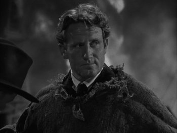 Movie still from “Boom Town” (1940), directed by Jack Conway – A black and white photo of a man in a suit and tie; Close Up shot, Low angle