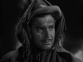 Movie still from “Boom Town” (1940), directed by Jack Conway – A black and white photo of a man with a hat on; Close Up shot, Low angle