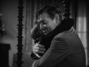 Movie still from “Boom Town” (1940), directed by Jack Conway – A black and white photo of a man and a woman hugging; Medium shot, High angle