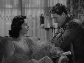 Movie still from “Boom Town” (1940), directed by Jack Conway – A man and a woman sitting on a couch; Medium shot, Over the shoulder angle