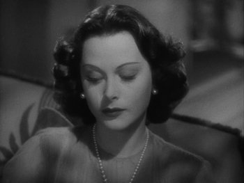 Movie still from “Boom Town” (1940), directed by Jack Conway – An old photo of a woman with a pearl necklace; Close Up shot, High angle