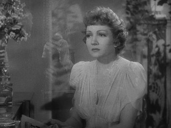 Movie still from “Boom Town” (1940), directed by Jack Conway – An old black and white photo of a woman looking out of a window; Close Up shot, Over the shoulder angle