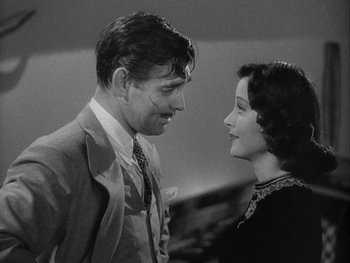 Movie still from “Boom Town” (1940), directed by Jack Conway – A man and a woman standing next to each other; Close Up shot, Low angle