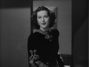 Movie still from “Boom Town” (1940), directed by Jack Conway – A black and white photo of a woman in a dress; Close Up shot, Low angle