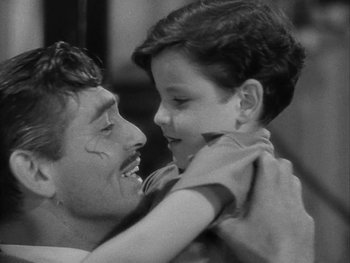 Movie still from “Boom Town” (1940), directed by Jack Conway – A man and a boy are hugging each other; Close Up shot, High angle