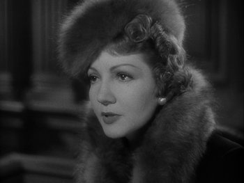 Movie still from “Boom Town” (1940), directed by Jack Conway – An old photo of a woman wearing a fur hat; Close Up shot, Low angle
