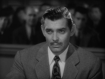 Movie still from “Boom Town” (1940), directed by Jack Conway – A man in a suit and tie; Close Up shot, Over the shoulder angle