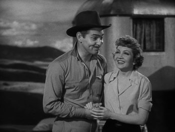Movie still from “Boom Town” (1940), directed by Jack Conway – A man and a woman standing next to each other; Medium shot, Low angle
