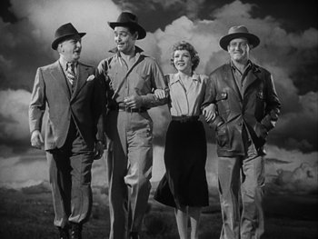 Movie still from “Boom Town” (1940), directed by Jack Conway – A black and white photo of a group of people walking together; Wide shot, Low angle