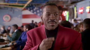 Movie still from “Boomerang” (1992), directed by Reginald Hudlin – A man in a red jacket and a black jacket; Close Up shot, Low angle