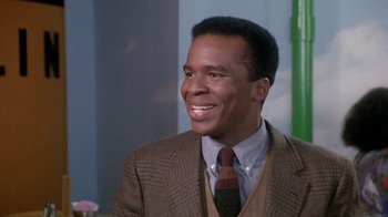 Movie still from “Boomerang” (1992), directed by Reginald Hudlin – A man wearing a suit and tie smiling; Close Up shot, Low angle
