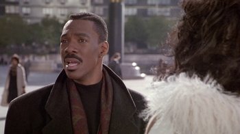 Movie still from “Boomerang” (1992), directed by Reginald Hudlin – A man in a black shirt is talking to a woman; Close Up shot, Over the shoulder angle