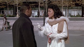 Movie still from “Boomerang” (1992), directed by Reginald Hudlin – A man and a woman talking to each other on the sidewalk; Medium shot, Over the shoulder angle