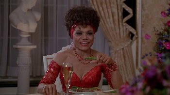 Movie still from “Boomerang” (1992), directed by Reginald Hudlin – A woman sitting at a table with a glass of wine; Close Up shot, High angle