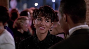 Movie still from “Boomerang” (1992), directed by Reginald Hudlin – A person wearing a black dress; Close Up shot, Over the shoulder angle