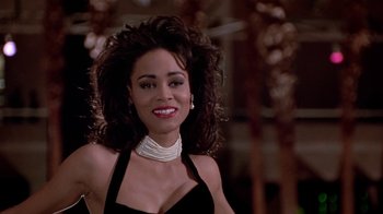 Movie still from “Boomerang” (1992), directed by Reginald Hudlin – A person wearing a necklace; Close Up shot, Low angle