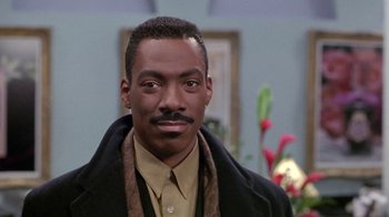 Movie still from “Boomerang” (1992), directed by Reginald Hudlin – A person wearing a coat; Close Up shot, Over the shoulder angle