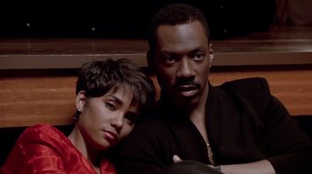 Movie still from “Boomerang” (1992), directed by Reginald Hudlin – A man and a woman pose for a picture; Close Up shot, High angle