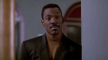 Movie still from “Boomerang” (1992), directed by Reginald Hudlin – A person wearing a suit and tie; Close Up shot, Low angle