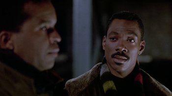 Movie still from “Boomerang” (1992), directed by Reginald Hudlin – Two men are standing next to each other; Close Up shot, Low angle