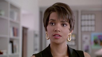 Movie still from “Boomerang” (1992), directed by Reginald Hudlin – A person with short brown hair; Close Up shot, Over the shoulder angle