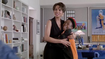 Movie still from “Boomerang” (1992), directed by Reginald Hudlin – A woman and a boy hugging in a living room; Medium shot, Low angle