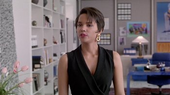 Movie still from “Boomerang” (1992), directed by Reginald Hudlin – A woman with short hair wearing a black dress; Close Up shot, Over the shoulder angle