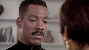 Movie still from “Boomerang” (1992), directed by Reginald Hudlin – A man with a mustache is talking to a woman; Close Up shot, Over the shoulder angle