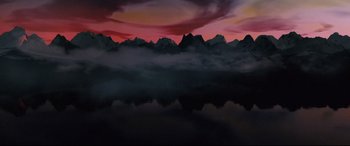 Movie still from “Borg vs. McEnroe” (2017), directed by Janus Metz – A painting of mountains and a body of water at sunset; Extreme Wide shot, Overhead angle