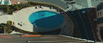 Movie still from “Borg vs. McEnroe” (2017), directed by Janus Metz – An aerial view of a swimming pool with a lot of benches around it; Extreme Wide shot, Overhead angle