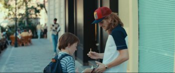 Movie still from “Borg vs. McEnroe” (2017), directed by Janus Metz – A man and a boy looking at a cell phone; Medium shot, Over the shoulder angle