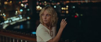 Movie still from “Borg vs. McEnroe” (2017), directed by Janus Metz – A woman is holding a cigarette in her hand; Close Up shot, Over the shoulder angle