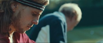 Movie still from “Borg vs. McEnroe” (2017), directed by Janus Metz – A person wearing a headband; Close Up shot, Over the shoulder angle