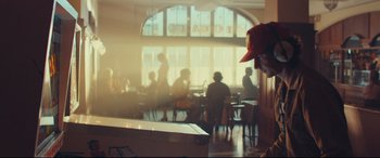 Movie still from “Borg vs. McEnroe” (2017), directed by Janus Metz – People are sitting at tables in a restaurant; Medium shot, Over the shoulder angle