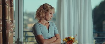 Movie still from “Borg vs. McEnroe” (2017), directed by Janus Metz – A woman sitting in front of a table with flowers; Close Up shot, Over the shoulder angle