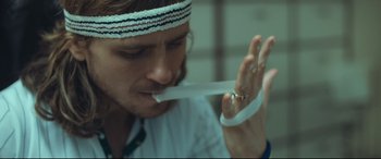 Movie still from “Borg vs. McEnroe” (2017), directed by Janus Metz – A person holding a white ribbon; Close Up shot, Low angle
