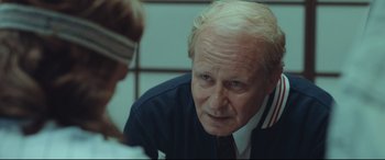 Movie still from “Borg vs. McEnroe” (2017), directed by Janus Metz – An older man is looking down at a woman; Close Up shot, Over the shoulder angle