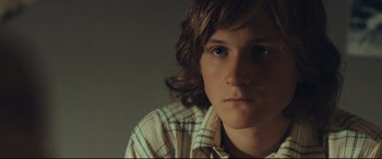 Movie still from “Borg vs. McEnroe” (2017), directed by Janus Metz – A person wearing a plaid shirt; Close Up shot, Over the shoulder angle