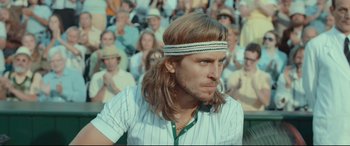 Movie still from “Borg vs. McEnroe” (2017), directed by Janus Metz – A person with long hair wearing a headband; Close Up shot, Over the shoulder angle